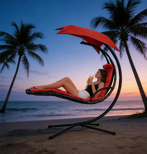 Woman relaxing on Freestanding Arc Stand Hanging Chaise Lounge Swing Chair With Curved Steel Frame on beach at sunset.