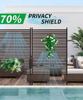Metal Outdoor Privacy Screen With Stand Freestanding 4 Ft Wide By 6 Ft High Privacy Fence Panel For Patio Garden Backyard Brown PE Coated Steel Slats Panels on patio with plants.