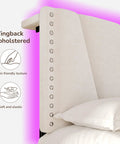 Close-up of wingback upholstered headboard in cozy beige, highlighting skin-friendly texture and elegant design features.