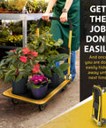 Heavy Duty Foldable Push Cart Dolly 330 Lb Capacity With Upgraded Collapsible Hand Truck in use with potted plants in a garden center