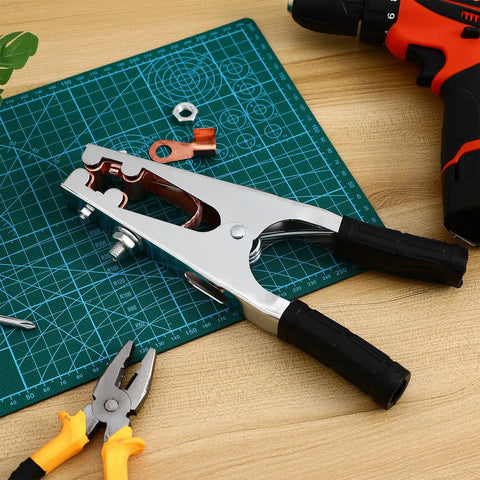 Heavy Duty Welder Ground Clamp With Reinforced Copper Jaw For Superior Grip And RockSolid Electrical Connection During Any Serious Fabrication Or Repair Job on a work surface with tools.