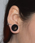 Person wearing 26 Piece Silicone Ear Tunnels Set 8G To 1 Inch Hollow Flexible Soft Ear Stretching Kit showing black tunnel in ear