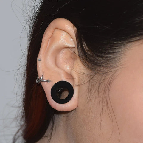Person wearing 26 Piece Silicone Ear Tunnels Set 8G To 1 Inch Hollow Flexible Soft Ear Stretching Kit showing black tunnel in ear