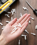 Top Shelf Spring Loaded Shutter Repair Pins Crisp White Long And Short Mix in hand for easy installation of plantation blinds.