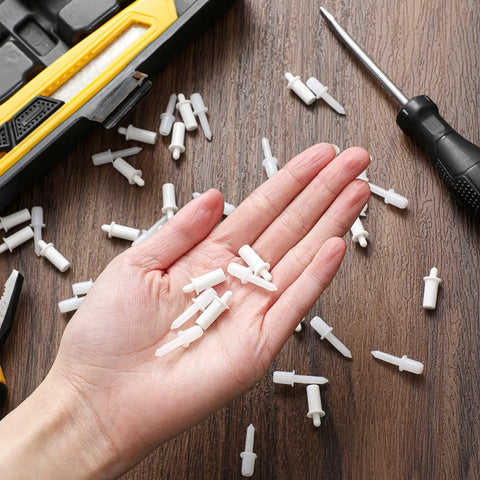 Top Shelf Spring Loaded Shutter Repair Pins Crisp White Long And Short Mix in hand for easy installation of plantation blinds.