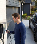 Man using Heavy Duty EV Charger Protector Stainless Steel Weatherproof Enclosure for outdoor EV charging.