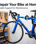 Bike Repair Stand For Home Mechanics And Gearheads Space Saving Bicycle Work Stand Holds Up To 44 Lbs Adjustable Non Damaging Clamp Fits 1.2 To 2.5 Inch Tubes Soft Silicone Grip Protects Finish showing a bike secured in a blue repair stand in a workshop.