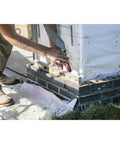 Builder using London Style Brick Trowel With DuraSoft Handle For Pro Grade Masonry Jobs 12 By 5 One Eighth Inch High Carbon Steel Forged Blade Ideal For Brick Block And Stonework Made In USA on brick foundation