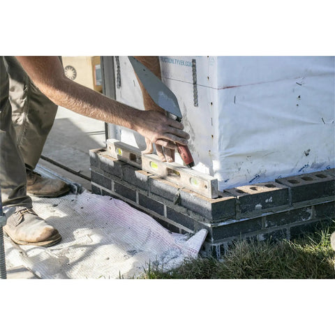 Builder using London Style Brick Trowel With DuraSoft Handle For Pro Grade Masonry Jobs 12 By 5 One Eighth Inch High Carbon Steel Forged Blade Ideal For Brick Block And Stonework Made In USA on brick foundation