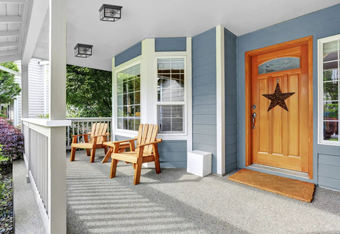 Porch with Country Star Square Two Light Farmhouse Ceiling Mount Fixture, dusk-to-dawn photocell, on blue house exterior with chairs.