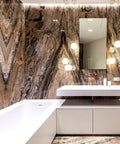Luxurious bathroom with stone wall, white bathtub, floating sink, reflective mirror, and soft lighting.