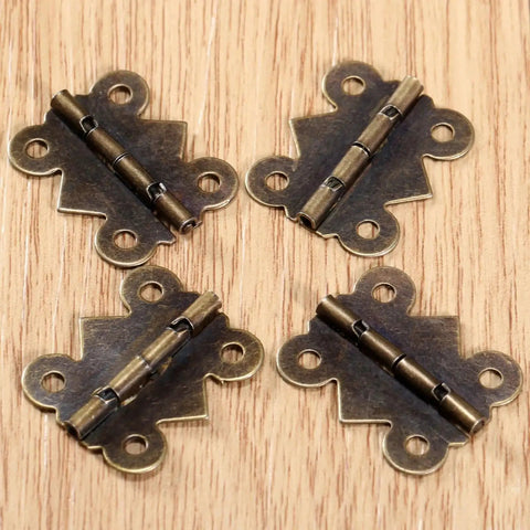 Antique Bronze Decorative Butterfly Hinges Set For Cabinets Drawers And Jewelry Boxes, 25mm By 20mm, 40 Pieces With Screws on wood surface