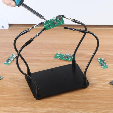 Helping Hands Soldering Station With Four Flexible Arms Magnetic Soldering Holder in use on a circuit board.