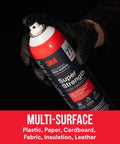 Person holding can of Multi Surface Spray Adhesive for light duty materials with fast dry time and low VOC, clear finish.