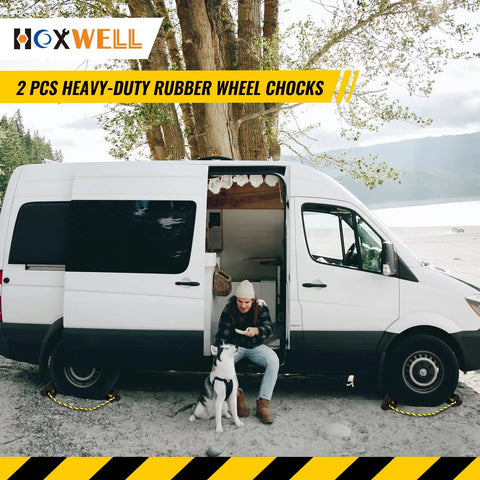 Heavy Duty Rubber Dual Wheel Chocks Set For RVs, Trailers And Trucks, shown under a parked van, 30 inch nylon rope, reflective tape