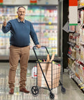 Man using Foldable Utility Shopping Cart With Double Baskets For Grocery And Laundry, Portable Wagon Cart On Wheels in store
