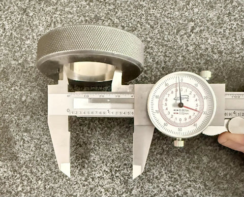 Six Inch Dial Caliper With Dual Metric And SAE Readout, Pro Grade Precision 0.001 Inch Resolution measuring a metal object