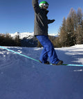 Person balancing on Slackline Kit 60ft Complete Set With Ratchet Training Line Bark Protectors And Instructions For Kids And Adults.