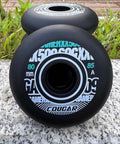 Inline Skate Wheels 4 Pack For Outdoor Indoor Use 78mm 80mm 85A With Bearings Roller Hockey Replacement Wheels Versatile Recreation Skates Smooth Glide And Dope Grip For A Smooth Long Lasting Ride. Front view of two black inline skate wheels with white text on a stone surface.