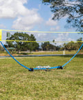 Backyard Badminton Set With Easy Setup Net 4 Steel Shaft Rackets 2 Durable Shuttlecocks installed on grass outdoors