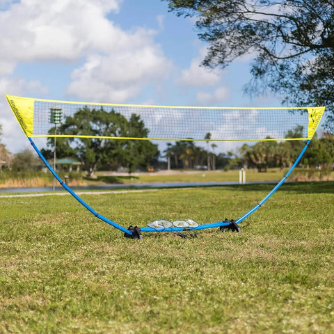 Backyard Badminton Set With Easy Setup Net 4 Steel Shaft Rackets 2 Durable Shuttlecocks installed on grass outdoors