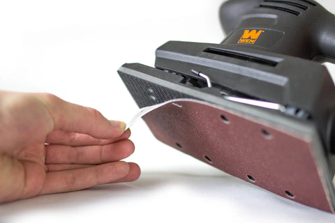 Applying sandpaper to Velcro base of Electric 1/3 Sheet Sander With 12,000 OPM, 3-5/8 X 7-3/8 Inch Sanding Pad, Ultra Lightweight 3 Pound Tool