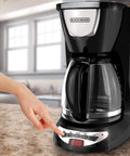 Person programming a Super Convenient Programmable 12 Cup Coffee Maker With Removable Glass Carafe For Making Delicious Fresh Hot Brew Every Single Morning Without Any Hassle