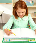 Girl in classroom writing with Durable 30 Pack Spanish Desk Nameplates Waterproof 4X14 Inch Name Tags For Classroom Use