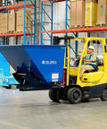 Super Top Notch Heavy Duty Steel Self Dumping Forklift Hopper with Straight Up Bump Release lifted by forklift in warehouse.