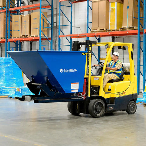 Super Top Notch Heavy Duty Steel Self Dumping Forklift Hopper with Straight Up Bump Release lifted by forklift in warehouse.