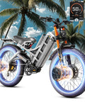 Badass 5600W Dual Motor Fat Tire Electric Mountain Bike For Adults With 60V 80Ah Long Range Battery Pushing 240 Miles At A Crazy 50 Mph Top End Full Air Suspension And Beefy Hydraulic Brakes Gray Includes Rack showcased against a tropical palm background.