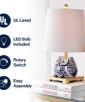Blue White Ceramic Owl Table Lamp With Linen Shade Cozy Modern Farmhouse Nightstand Light For Bedroom Or Office LED Bulb Included Energy Efficient ETL Listed featuring owl design and hardback cotton drum shade on nightstand.