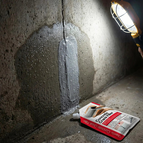 Two Pack 2.2 Pound Grey Concrete Crack Filler Self Leveling Sealant applied on wall with product tube in view