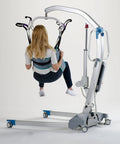 Toileting Transfer Sling With Torso Belt For Elderly Patients in use with patient lift, size XL, comfy polyester material.