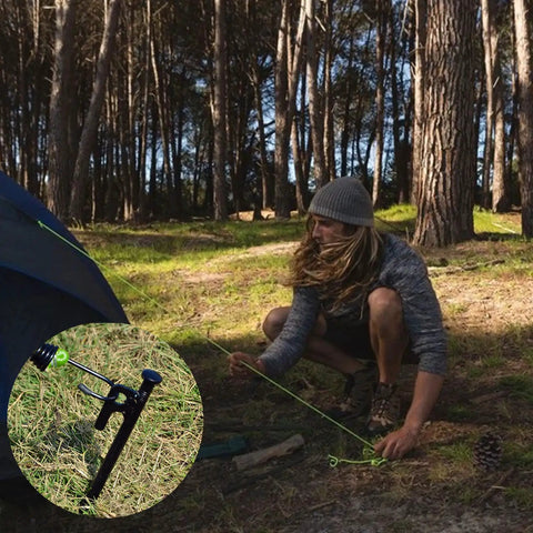 Person using Beefy 8 Pack Tent Stakes Heavy Duty Metal Pegs For Camping Eight Inch Steel Ground Anchors in forest setting
