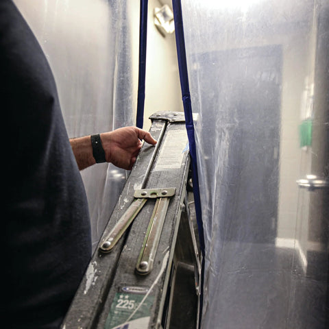 E-Z UP magnetic dust containment door kit on a clear outdoor shelter; blue magnetic strips visible.