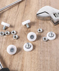 Six Piece Set Of 19mm White Plastic Drawer Rollers Featuring Slick Cabinet Pulleys For Smooth Operator Furniture Gliding No Sweat Replacement Wheels With Heavy Duty Mounting Nuts, showing white plastic rollers and mounting nuts.