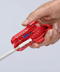 Hand using Workhorse Ergostrip Cable Stripping Tool with ergonomic pistol grip on white round damp-proof cable.