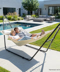 Couple relaxing on hammock with Beefy Heavy Duty Hammock Stand With Adjustable Frame For Outdoors Portable Double Bar Design 550 LB Capacity Black Iron Frame in garden