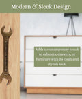 Antique Metal Wrench Drawer Pull For Cabinets And Tool Chests on wooden surface next to white chest of drawers.