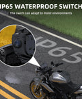 12V Waterproof Round Rocker Switch With Blue LED Light on wet motorcycle surface, showcasing IP65 weatherproof feature
