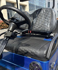 Heavy Duty Electric Golf Cart With Four Kilowatt Motor And Easy Directional Controls two-seat cockpit with steering wheel and textured seats.
