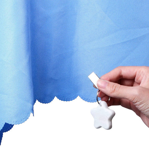 Hand clipping Starfish Tablecloth Weights Set With Metal Clips to blue tablecloth for outdoor picnics, keeping linens flat.