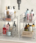 Clear Two Tier Under Sink Sliding Organizer With Adjustable Dividers Heavy Duty Waterproof Cabinet Rack For Bathroom Pantry with toiletries.