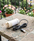 Portable Submersible Sump Pump With Built In Filter And Extended Drain Hose Heavy Duty Water Rig on a stone table with USB cable.