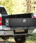 Road Ready Heavy Duty Aluminum Truck Bed Toolbox Featuring Diamond Plate Shield And Tamper Proof Latching For Rough Daily Runs And Tailgate Chasing 48 Inch Black Storage Case in truck bed.