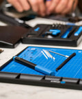 Magnetic FixMat Electronics Repair Mat With Dry Erase Grid And Sorting Bins organized with tools for pro techs and DIYers.