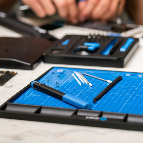 Magnetic FixMat Electronics Repair Mat With Dry Erase Grid And Sorting Bins organized with tools for pro techs and DIYers.
