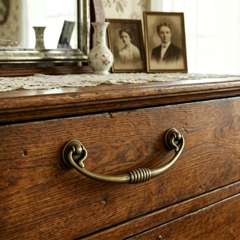 Vintage Bail Drawer Pulls 4 Pack Antique Brass Drop Handles on wooden dresser with lace and vintage photos