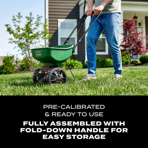 Person using Turf Builder EdgeGuard Mini Broadcast Spreader For Lawns, Spreads Grass Seed Fertilizer And Salt Like A Pro